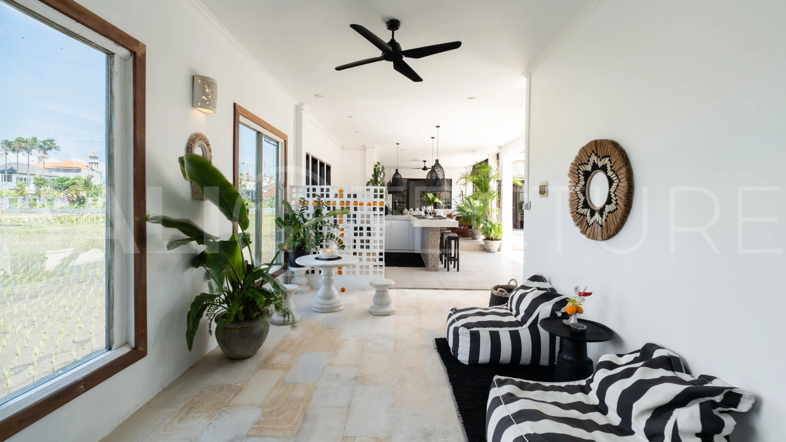 3-bedroom ricefield view villa for sale in Seminyak, featuring a private swimming pool, tropical garden, spacious living areas, and a peaceful residential setting.