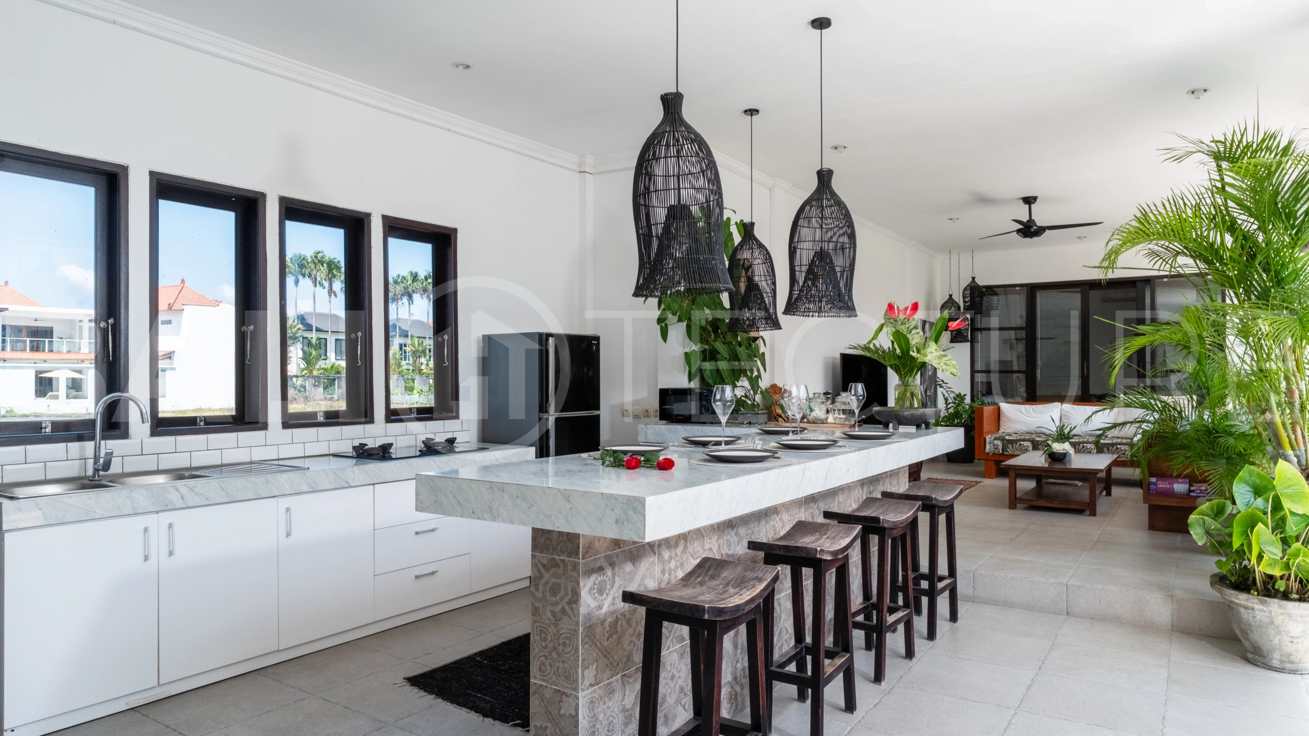 3-bedroom ricefield view villa for sale in Seminyak, featuring a private swimming pool, tropical garden, spacious living areas, and a peaceful residential setting.