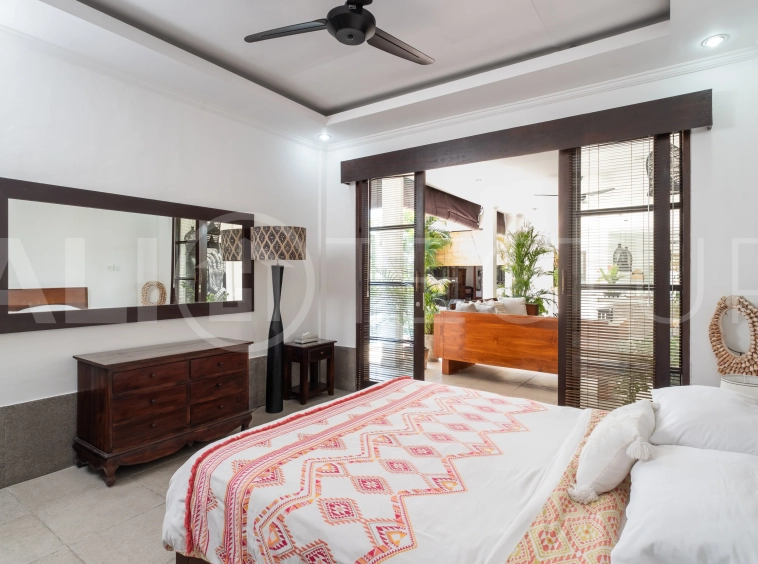 3-bedroom ricefield view villa for sale in Seminyak, featuring a private swimming pool, tropical garden, spacious living areas, and a peaceful residential setting.