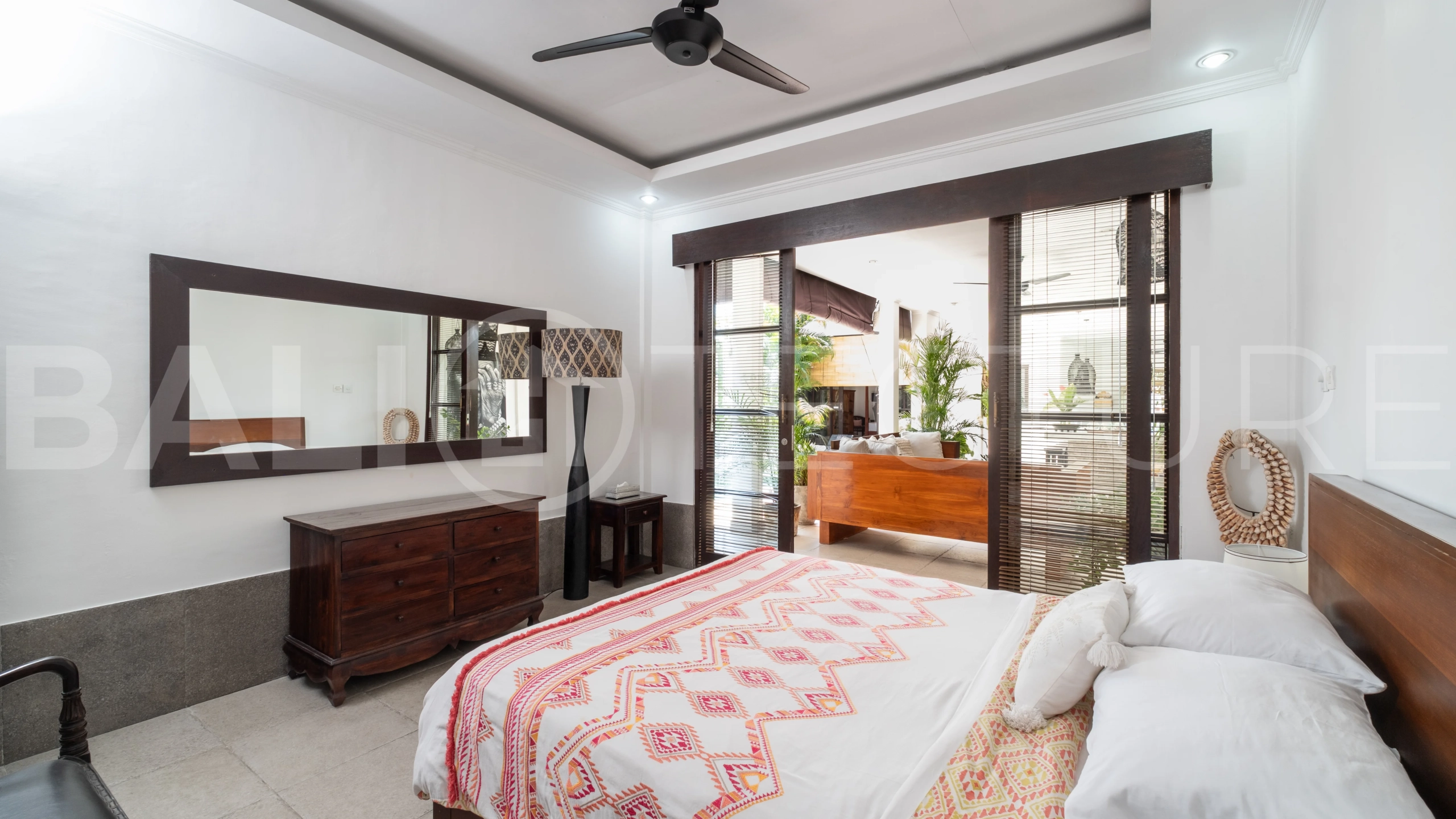 3-bedroom ricefield view villa for sale in Seminyak, featuring a private swimming pool, tropical garden, spacious living areas, and a peaceful residential setting.