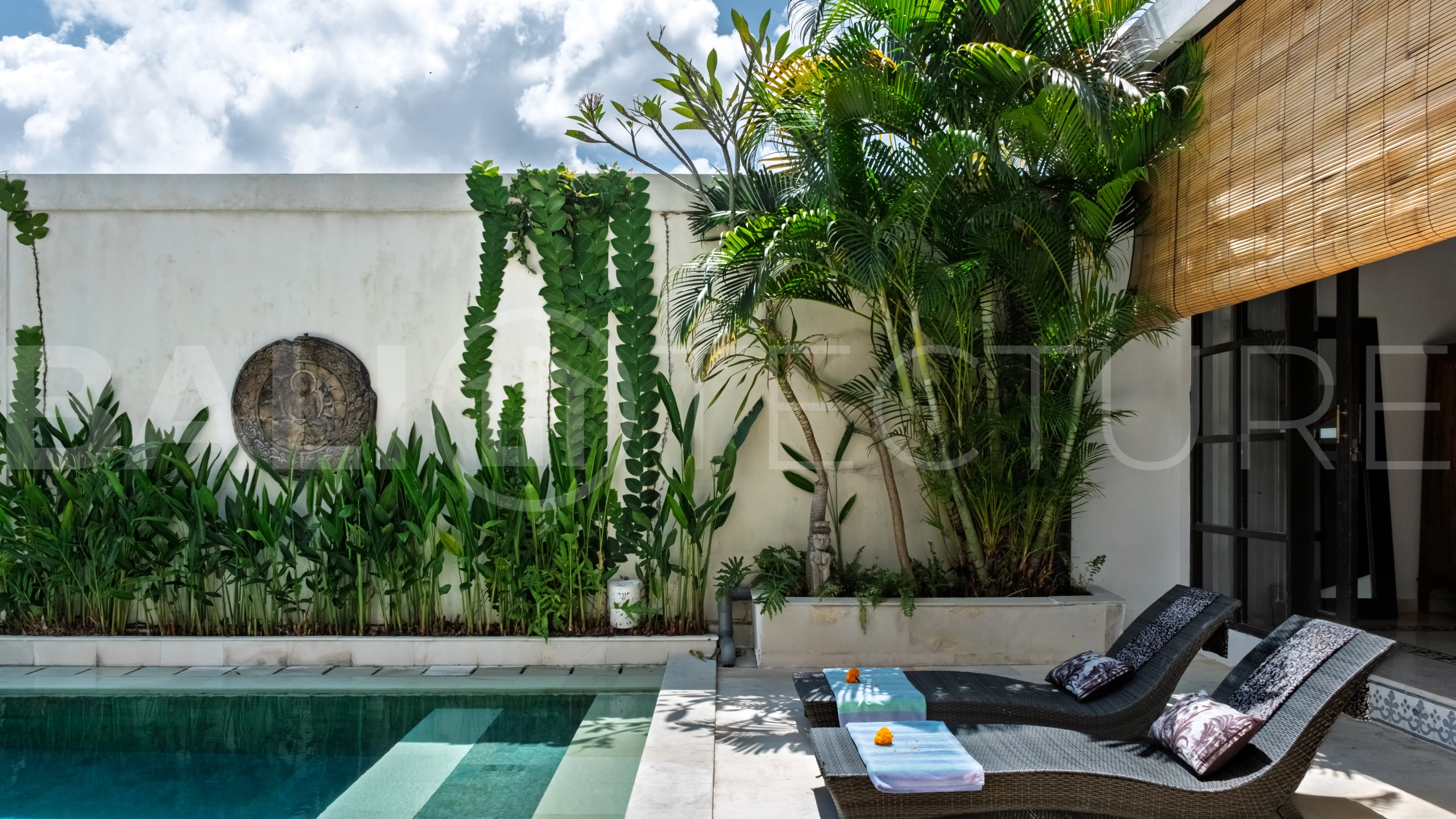 3-bedroom ricefield view villa for sale in Seminyak, featuring a private swimming pool, tropical garden, spacious living areas, and a peaceful residential setting.