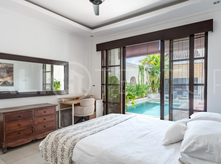 3-bedroom ricefield view villa for sale in Seminyak, featuring a private swimming pool, tropical garden, spacious living areas, and a peaceful residential setting.