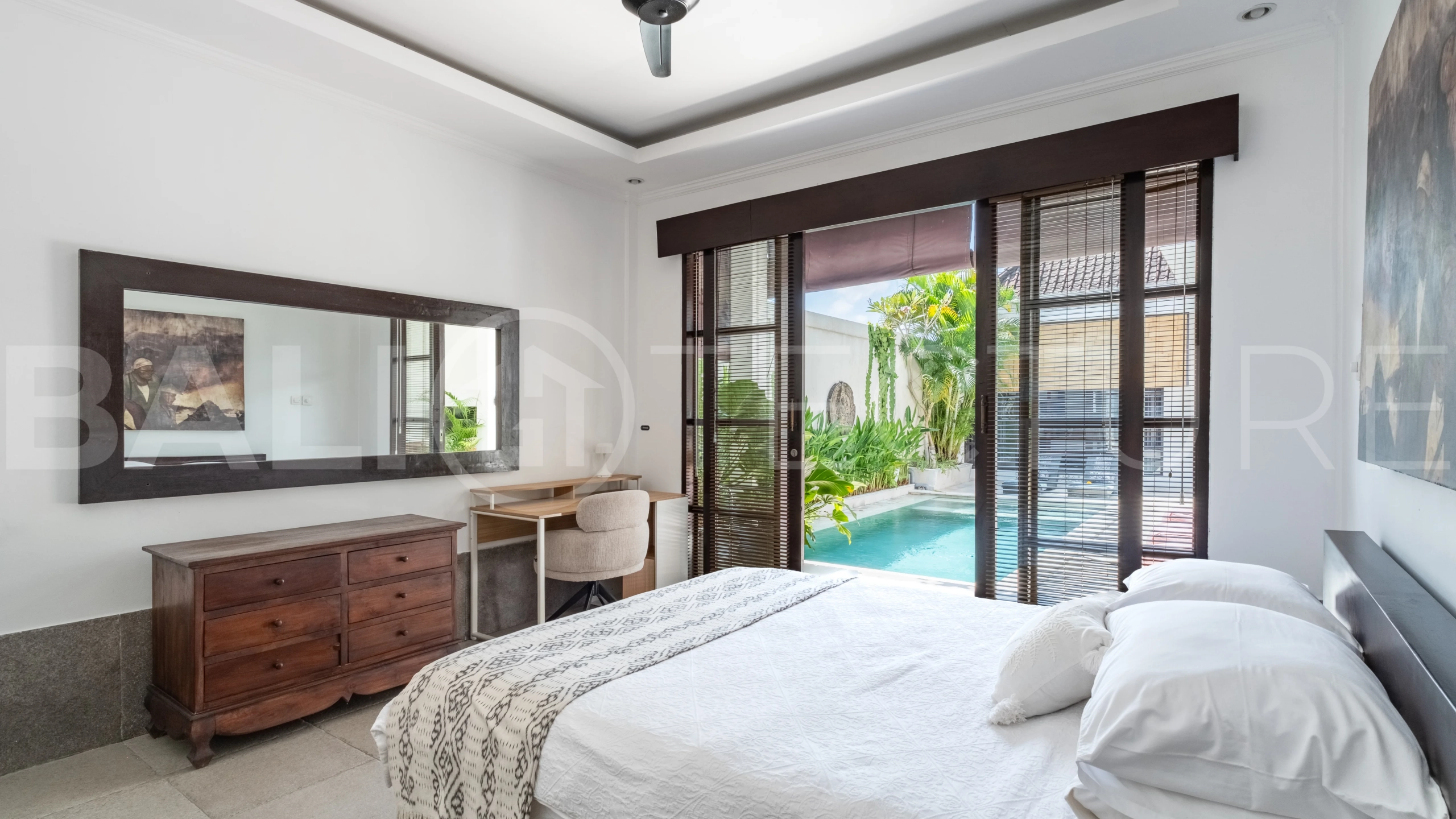 3-bedroom ricefield view villa for sale in Seminyak, featuring a private swimming pool, tropical garden, spacious living areas, and a peaceful residential setting.