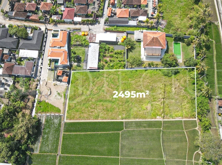 2,495 m² yellow-zone leasehold land for sale in Nyambu, Kaba Kaba, with rectangular shape, car and motorbike access, and scenic rice field and mountain views.