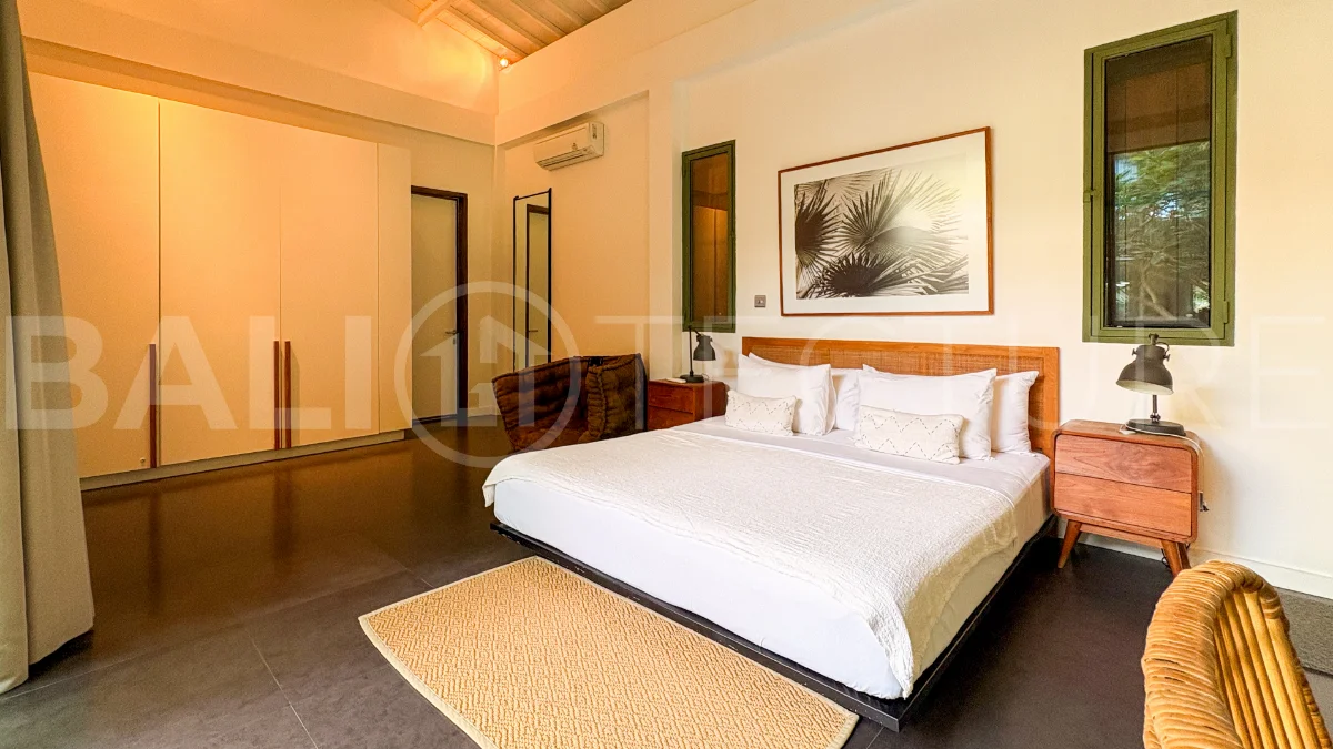 Modern four-bedroom villa in Tumbak Bayuh, Pererenan, featuring a private 12-meter swimming pool, tropical garden, double-height living area, spacious outdoor terrace, and contemporary furnished interiors on a 5.5-are plot.