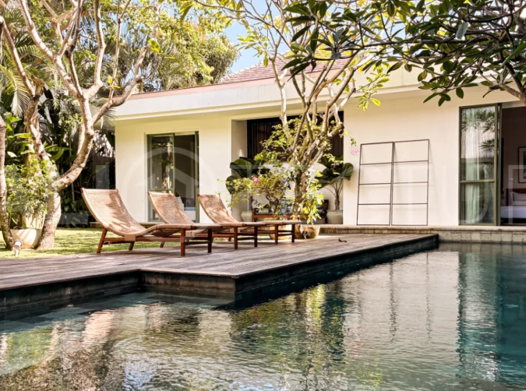 Modern four-bedroom villa in Tumbak Bayuh, Pererenan, featuring a private 12-meter swimming pool, tropical garden, double-height living area, spacious outdoor terrace, and contemporary furnished interiors on a 5.5-are plot.