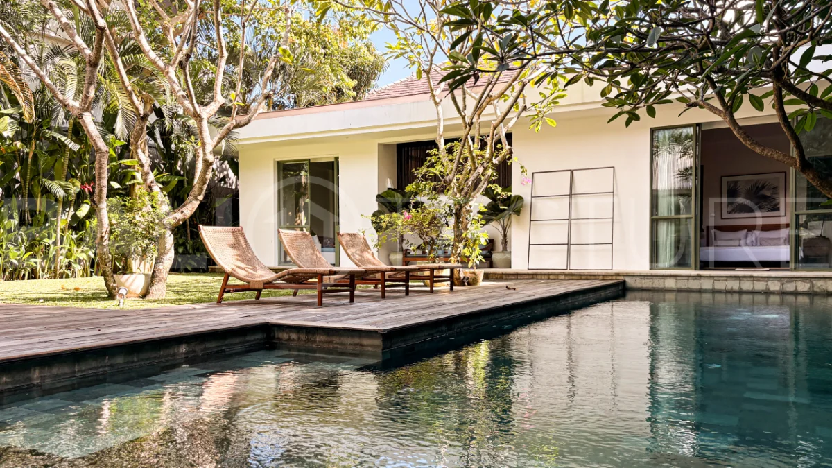 Modern four-bedroom villa in Tumbak Bayuh, Pererenan, featuring a private 12-meter swimming pool, tropical garden, double-height living area, spacious outdoor terrace, and contemporary furnished interiors on a 5.5-are plot.