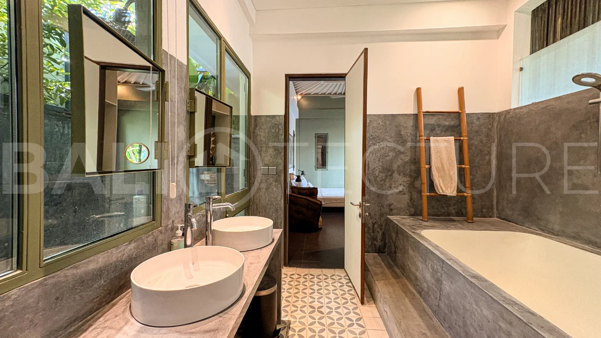 Modern four-bedroom villa in Tumbak Bayuh, Pererenan, featuring a private 12-meter swimming pool, tropical garden, double-height living area, spacious outdoor terrace, and contemporary furnished interiors on a 5.5-are plot.