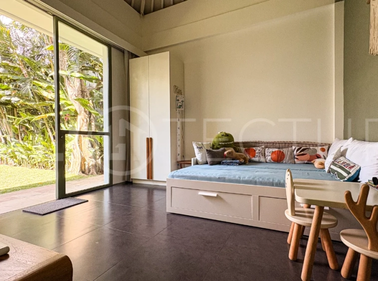 Modern four-bedroom villa in Tumbak Bayuh, Pererenan, featuring a private 12-meter swimming pool, tropical garden, double-height living area, spacious outdoor terrace, and contemporary furnished interiors on a 5.5-are plot.
