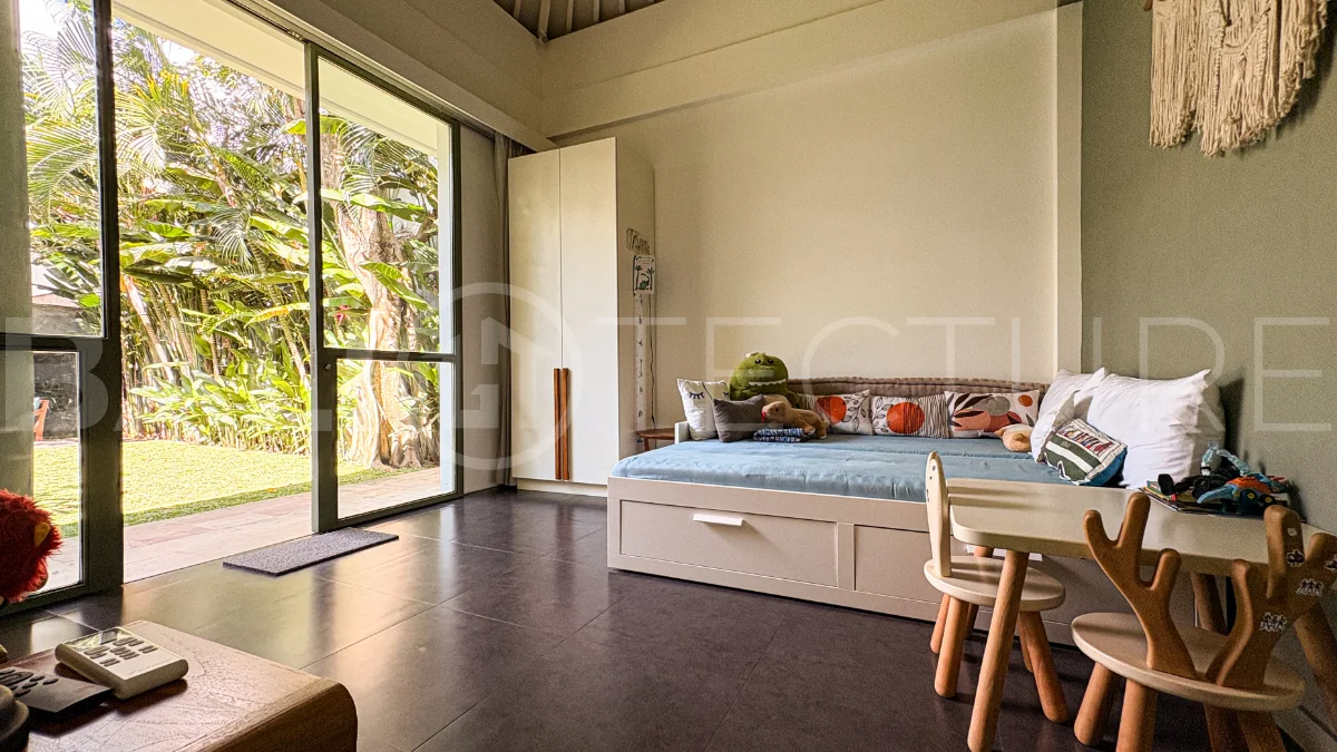 Modern four-bedroom villa in Tumbak Bayuh, Pererenan, featuring a private 12-meter swimming pool, tropical garden, double-height living area, spacious outdoor terrace, and contemporary furnished interiors on a 5.5-are plot.