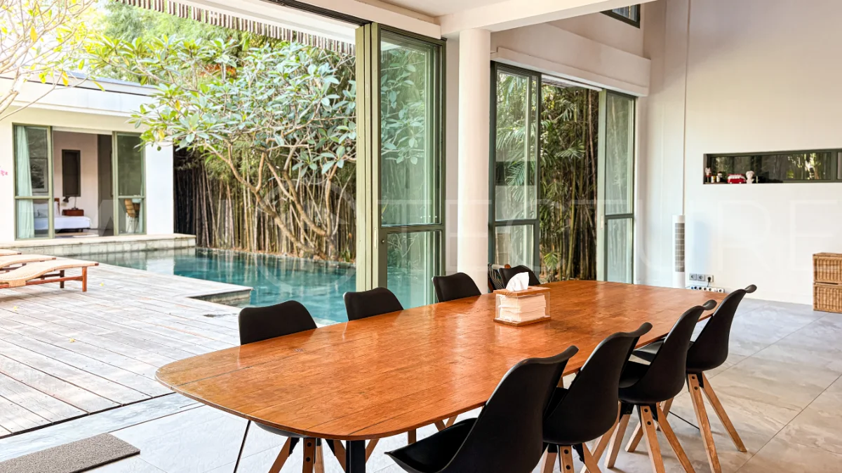Modern four-bedroom villa in Tumbak Bayuh, Pererenan, featuring a private 12-meter swimming pool, tropical garden, double-height living area, spacious outdoor terrace, and contemporary furnished interiors on a 5.5-are plot.
