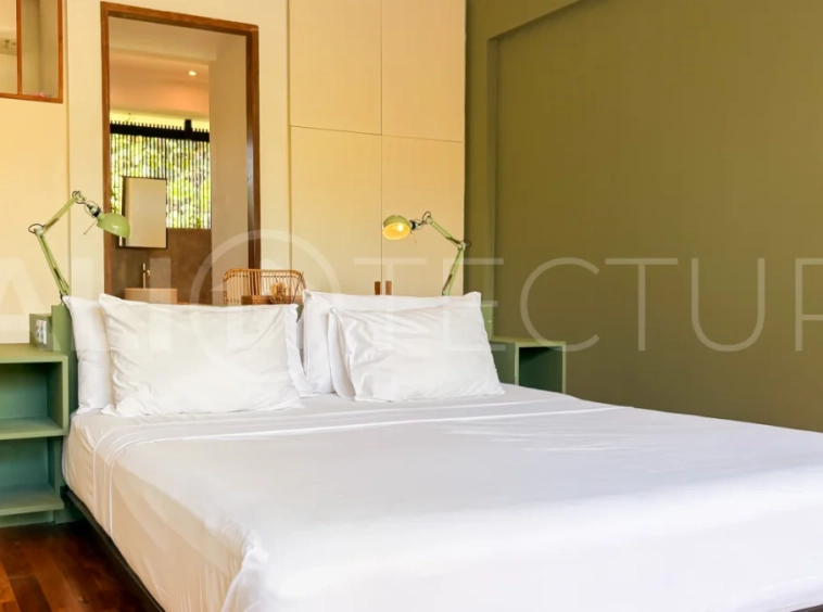 Modern four-bedroom villa in Tumbak Bayuh, Pererenan, featuring a private 12-meter swimming pool, tropical garden, double-height living area, spacious outdoor terrace, and contemporary furnished interiors on a 5.5-are plot.