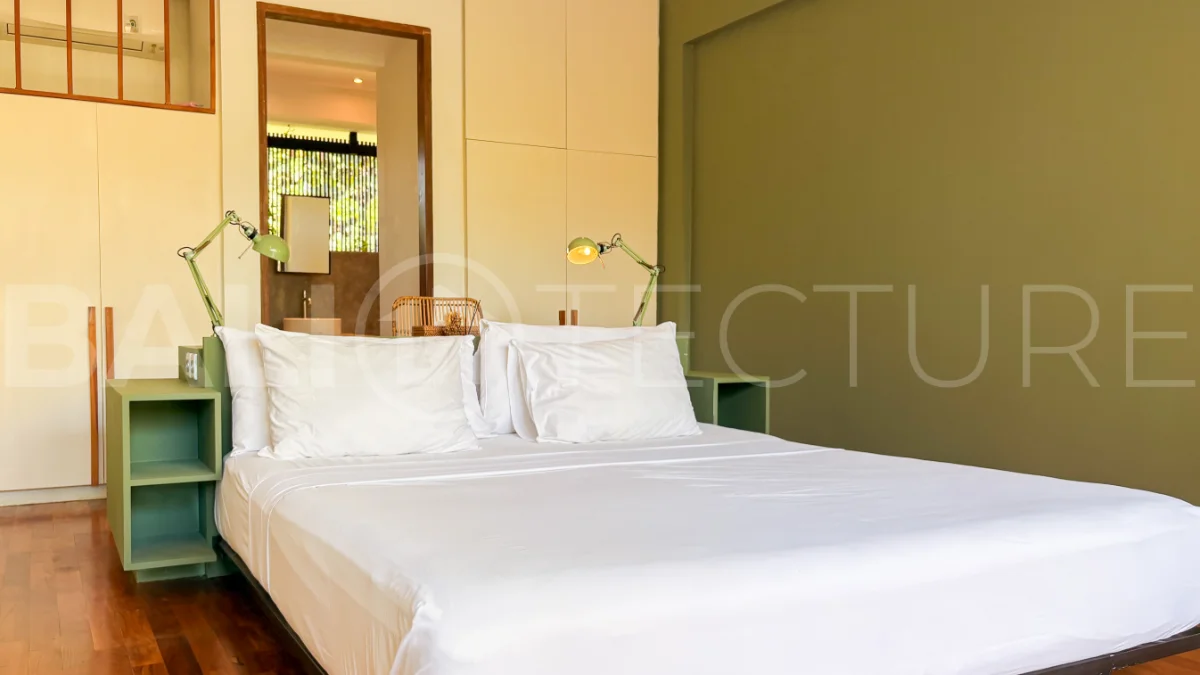 Modern four-bedroom villa in Tumbak Bayuh, Pererenan, featuring a private 12-meter swimming pool, tropical garden, double-height living area, spacious outdoor terrace, and contemporary furnished interiors on a 5.5-are plot.