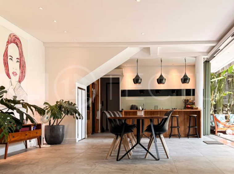 Modern four-bedroom villa in Tumbak Bayuh, Pererenan, featuring a private 12-meter swimming pool, tropical garden, double-height living area, spacious outdoor terrace, and contemporary furnished interiors on a 5.5-are plot.