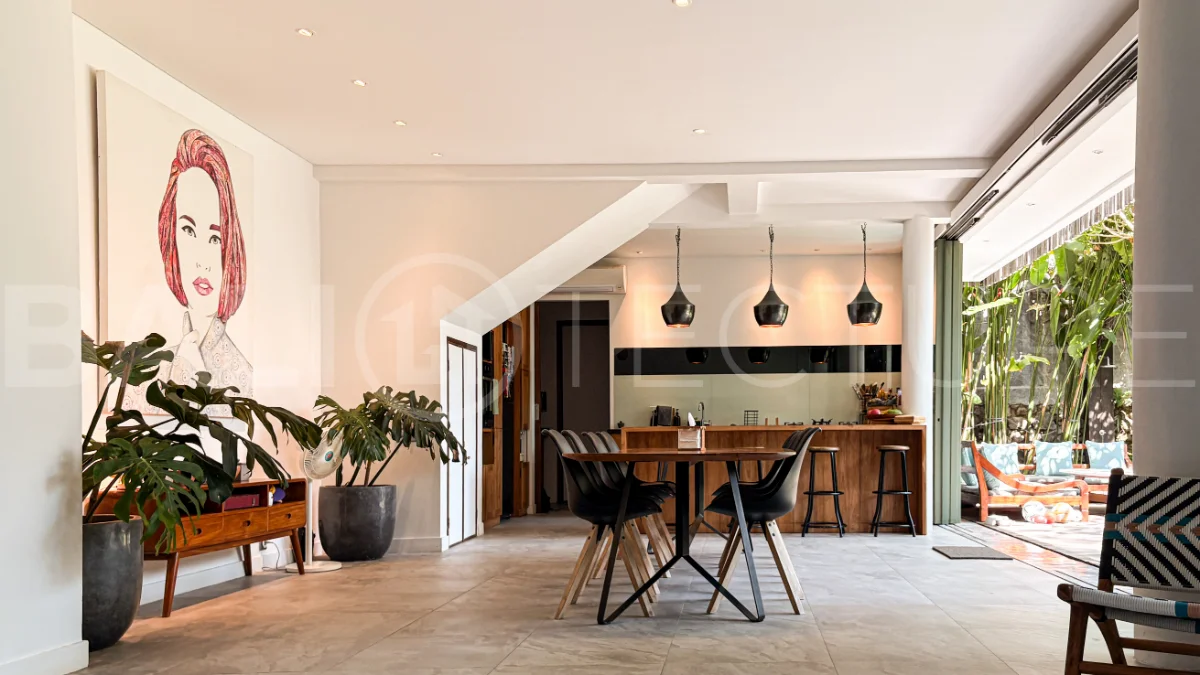 Modern four-bedroom villa in Tumbak Bayuh, Pererenan, featuring a private 12-meter swimming pool, tropical garden, double-height living area, spacious outdoor terrace, and contemporary furnished interiors on a 5.5-are plot.