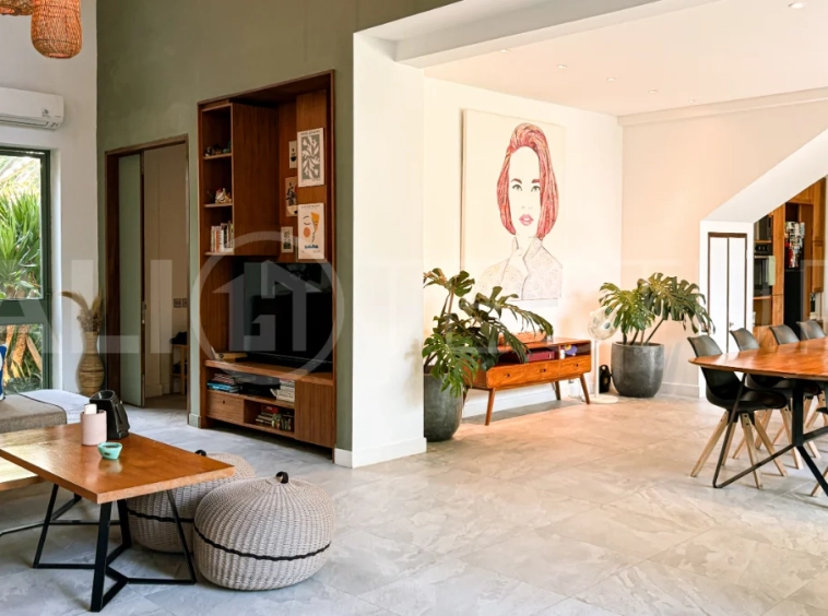 Modern four-bedroom villa in Tumbak Bayuh, Pererenan, featuring a private 12-meter swimming pool, tropical garden, double-height living area, spacious outdoor terrace, and contemporary furnished interiors on a 5.5-are plot.