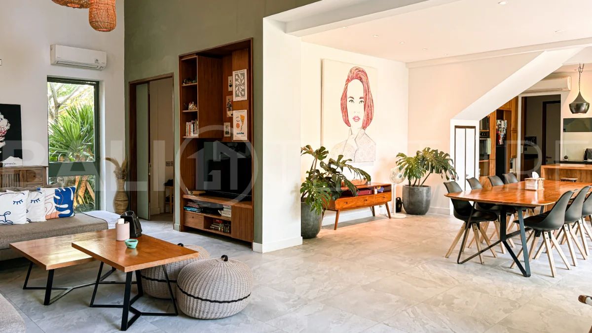 Modern four-bedroom villa in Tumbak Bayuh, Pererenan, featuring a private 12-meter swimming pool, tropical garden, double-height living area, spacious outdoor terrace, and contemporary furnished interiors on a 5.5-are plot.