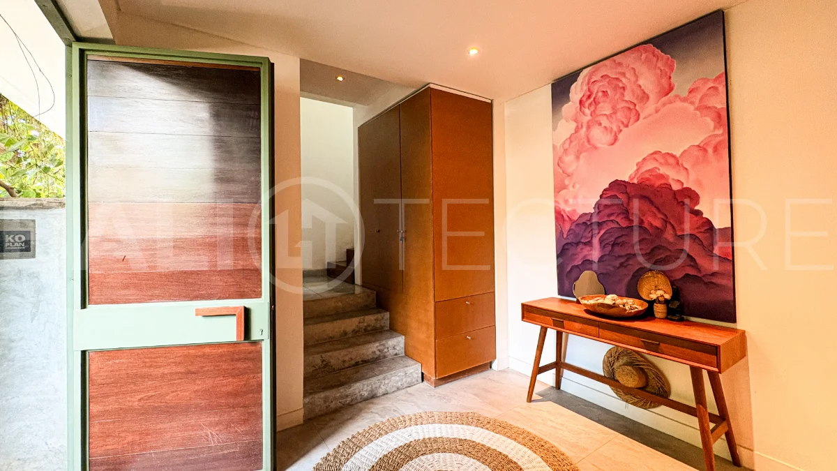 Modern four-bedroom villa in Tumbak Bayuh, Pererenan, featuring a private 12-meter swimming pool, tropical garden, double-height living area, spacious outdoor terrace, and contemporary furnished interiors on a 5.5-are plot.