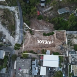 Aerial view of 1,073m² leasehold land for sale near Bingin Beach, Uluwatu, overlooking the ocean with stunning sunset views, surrounded by villas, cafés, restaurants, and coastal developments.