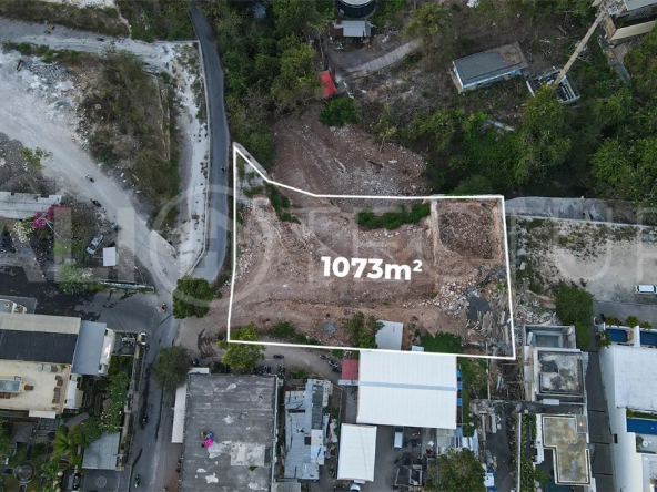 Aerial view of 1,073m² leasehold land for sale near Bingin Beach, Uluwatu, overlooking the ocean with stunning sunset views, surrounded by villas, cafés, restaurants, and coastal developments.