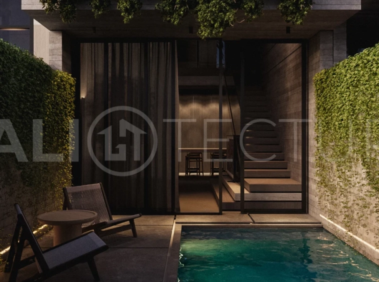 Modern one bedroom villa near Pererenan Beach in Bali, featuring a private pool, tropical landscaping, natural stone and teak wood finishes, panoramic glazing, and a stylish resort inspired interior.