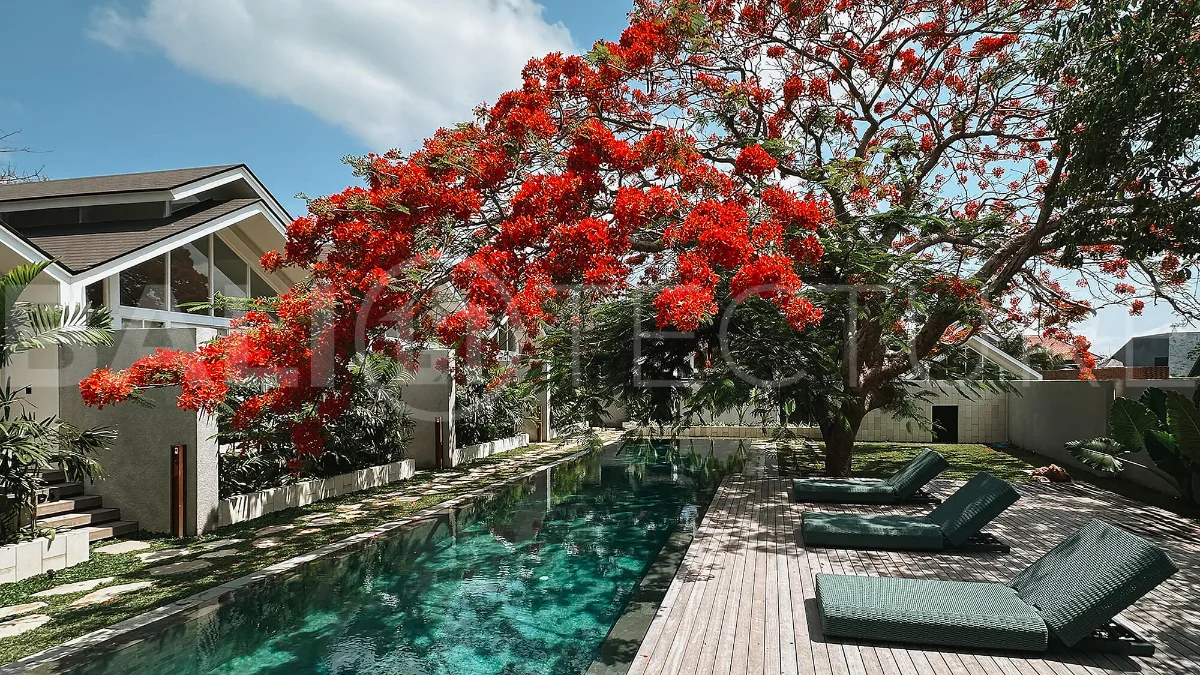 105 m² villa for sale near Jimbaran Beach featuring a tropical garden, outdoor bathtub, open-plan living and kitchen area, and direct access to an infinity pool.