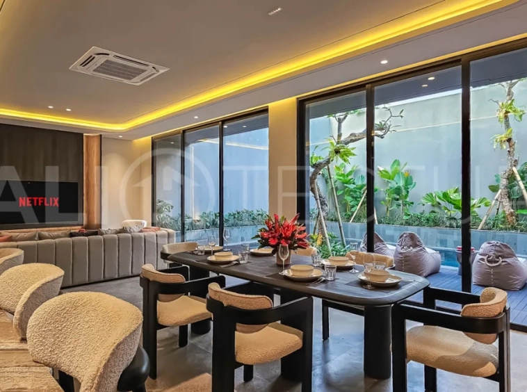 Modern two-storey luxury villa in Ubud featuring a private swimming pool, lush tropical landscaping, floor-to-ceiling glass doors, and a stylish contemporary exterior.