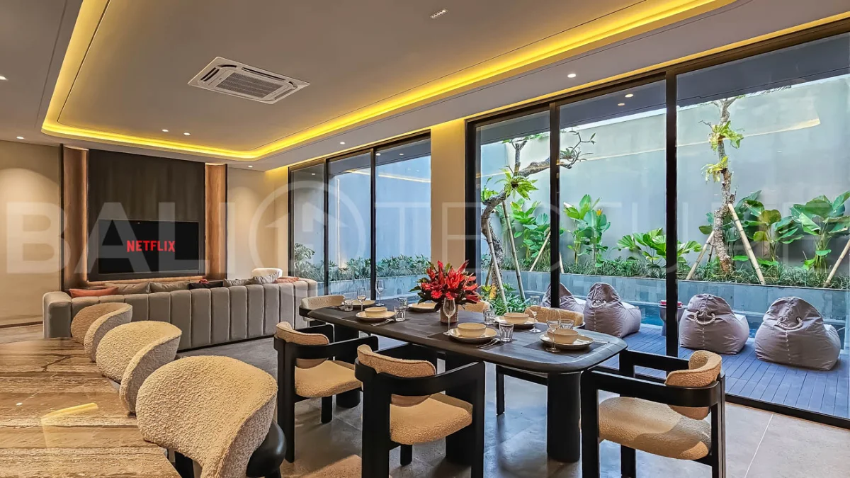 Modern two-storey luxury villa in Ubud featuring a private swimming pool, lush tropical landscaping, floor-to-ceiling glass doors, and a stylish contemporary exterior.