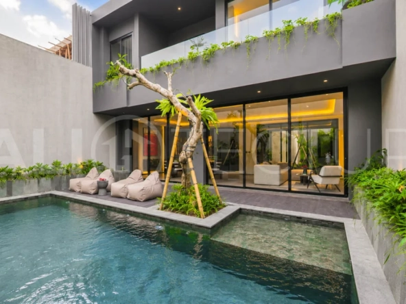 Modern two-storey luxury villa in Ubud featuring a private swimming pool, lush tropical landscaping, floor-to-ceiling glass doors, and a stylish contemporary exterior.