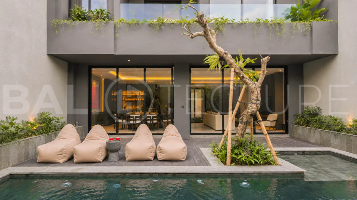Modern two-storey luxury villa in Ubud featuring a private swimming pool, lush tropical landscaping, floor-to-ceiling glass doors, and a stylish contemporary exterior.