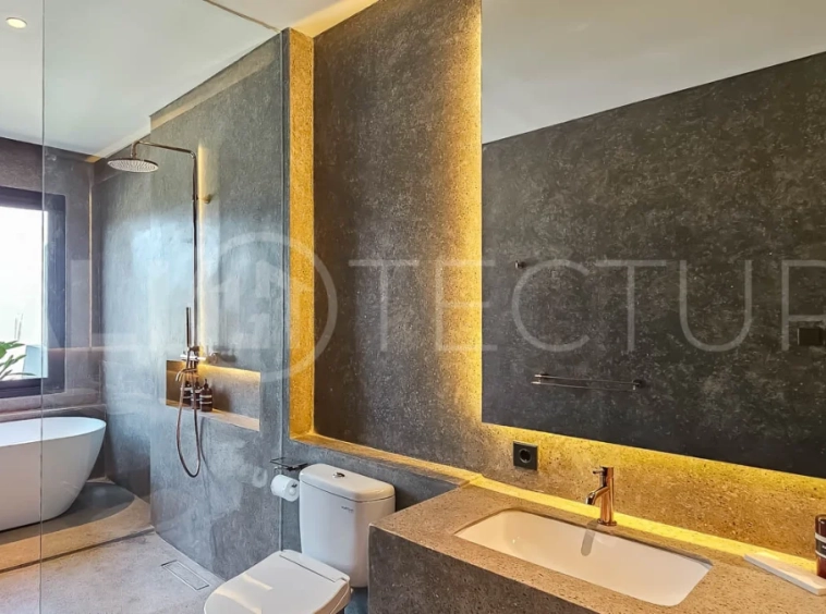 Modern two-storey luxury villa in Ubud featuring a private swimming pool, lush tropical landscaping, floor-to-ceiling glass doors, and a stylish contemporary exterior.