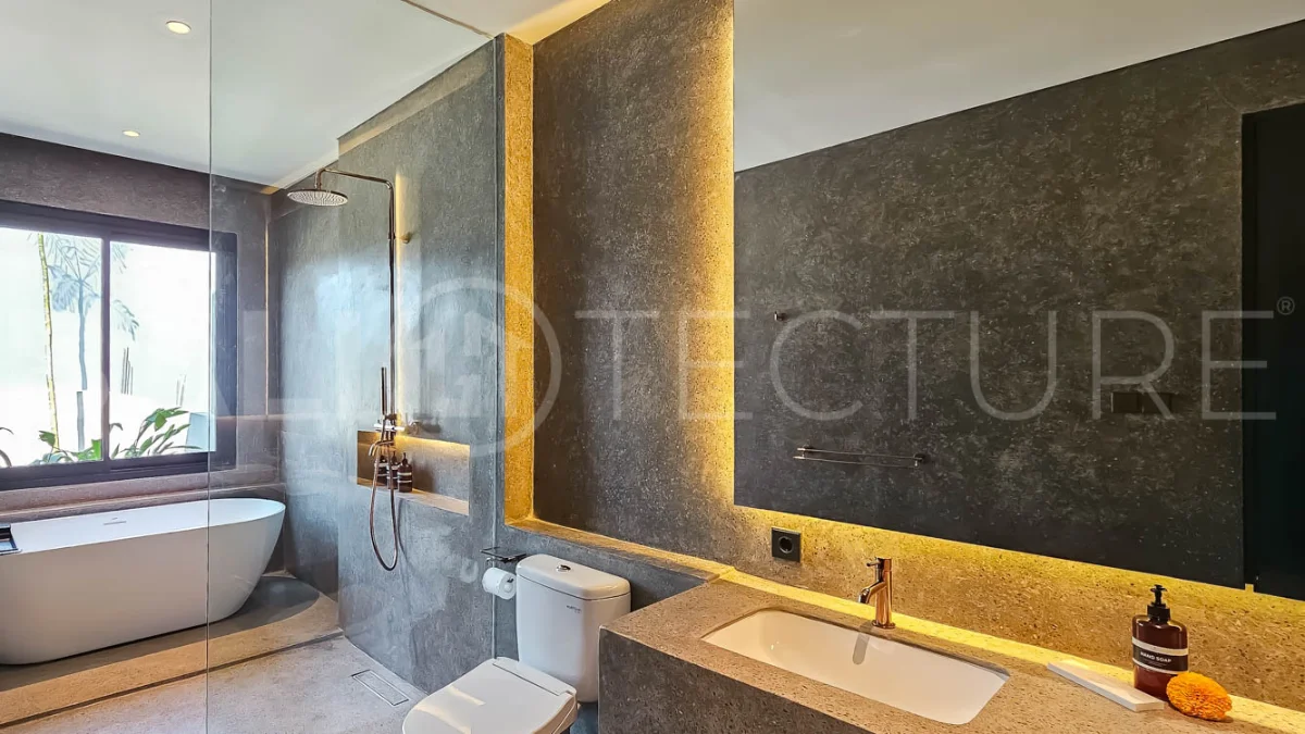 Modern two-storey luxury villa in Ubud featuring a private swimming pool, lush tropical landscaping, floor-to-ceiling glass doors, and a stylish contemporary exterior.