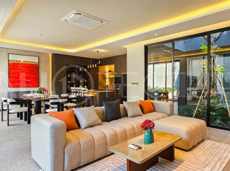 Modern two-storey luxury villa in Ubud featuring a private swimming pool, lush tropical landscaping, floor-to-ceiling glass doors, and a stylish contemporary exterior.