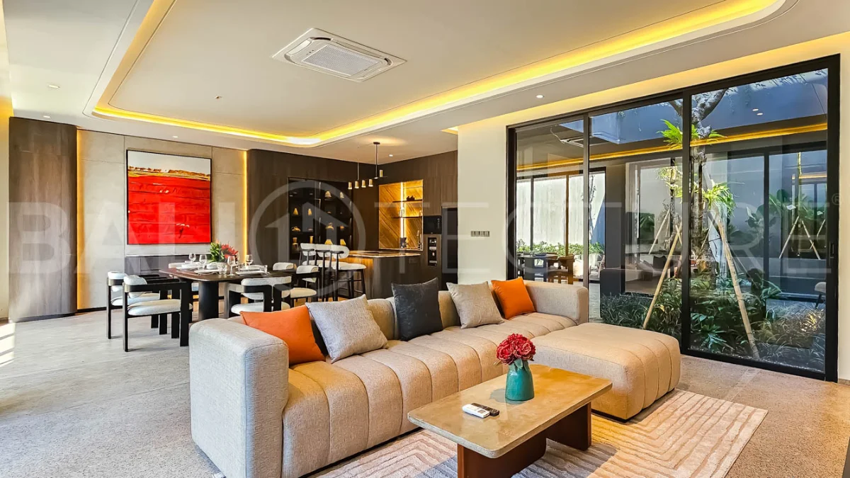 Modern two-storey luxury villa in Ubud featuring a private swimming pool, lush tropical landscaping, floor-to-ceiling glass doors, and a stylish contemporary exterior.