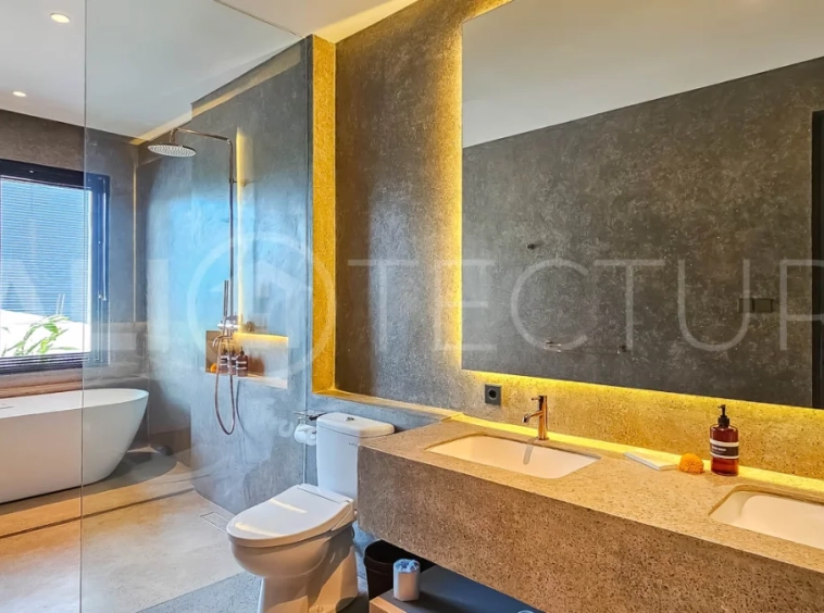Modern two-storey luxury villa in Ubud featuring a private swimming pool, lush tropical landscaping, floor-to-ceiling glass doors, and a stylish contemporary exterior.