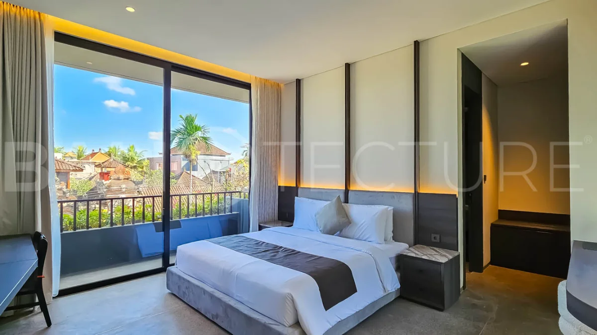 Modern two-storey luxury villa in Ubud featuring a private swimming pool, lush tropical landscaping, floor-to-ceiling glass doors, and a stylish contemporary exterior.