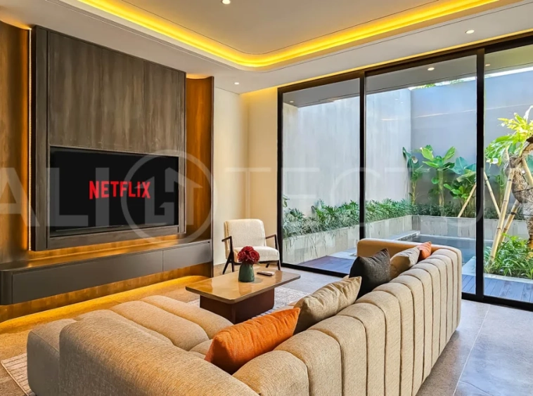 Modern two-storey luxury villa in Ubud featuring a private swimming pool, lush tropical landscaping, floor-to-ceiling glass doors, and a stylish contemporary exterior.