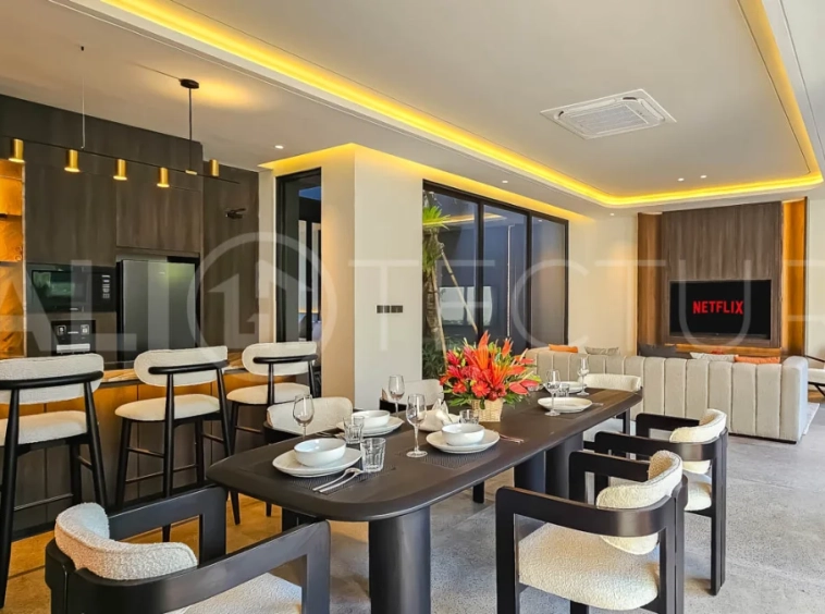 Modern two-storey luxury villa in Ubud featuring a private swimming pool, lush tropical landscaping, floor-to-ceiling glass doors, and a stylish contemporary exterior.