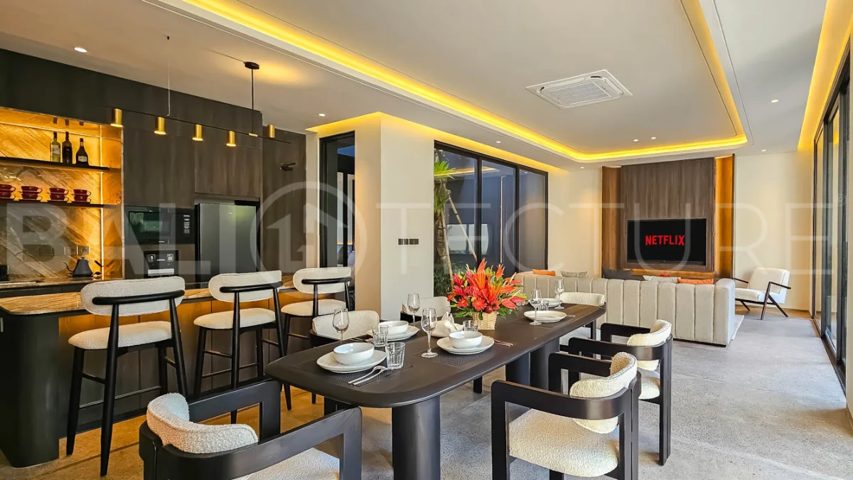 Modern two-storey luxury villa in Ubud featuring a private swimming pool, lush tropical landscaping, floor-to-ceiling glass doors, and a stylish contemporary exterior.