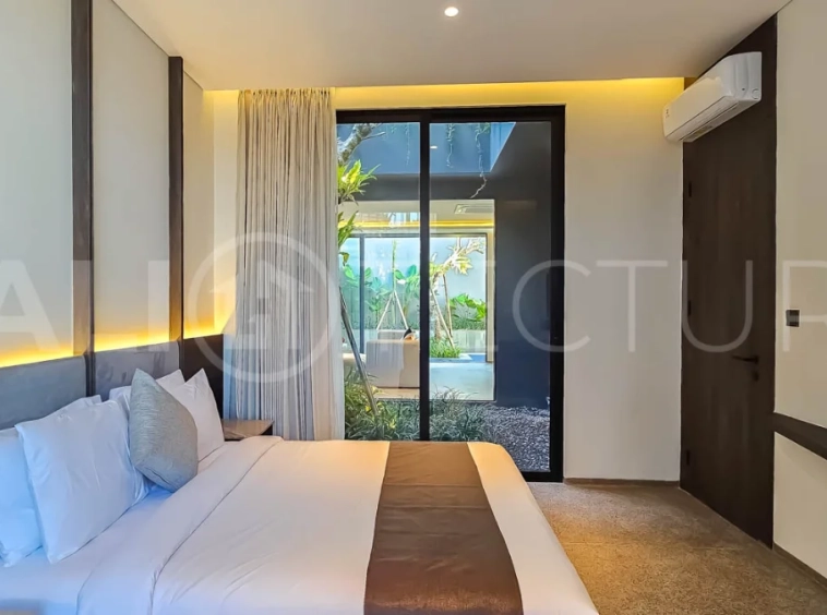 Modern two-storey luxury villa in Ubud featuring a private swimming pool, lush tropical landscaping, floor-to-ceiling glass doors, and a stylish contemporary exterior.