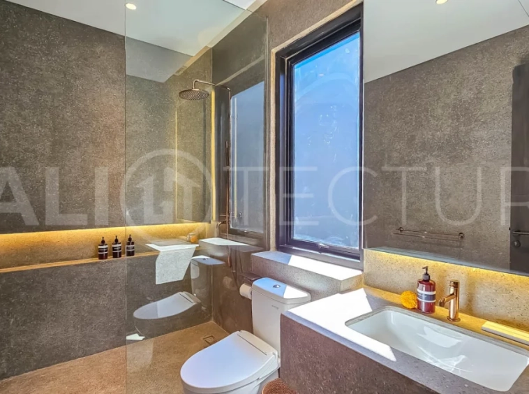 Modern two-storey luxury villa in Ubud featuring a private swimming pool, lush tropical landscaping, floor-to-ceiling glass doors, and a stylish contemporary exterior.
