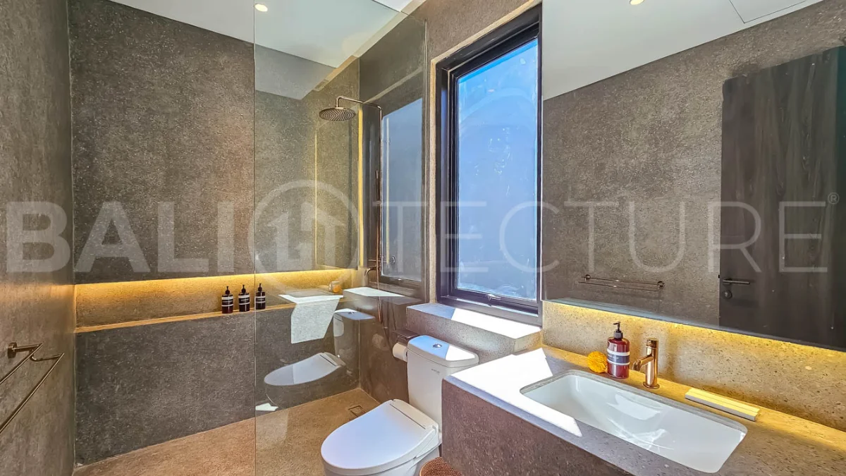 Modern two-storey luxury villa in Ubud featuring a private swimming pool, lush tropical landscaping, floor-to-ceiling glass doors, and a stylish contemporary exterior.