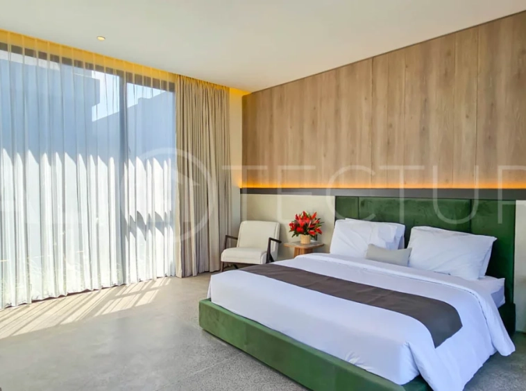 Modern two-storey luxury villa in Ubud featuring a private swimming pool, lush tropical landscaping, floor-to-ceiling glass doors, and a stylish contemporary exterior.