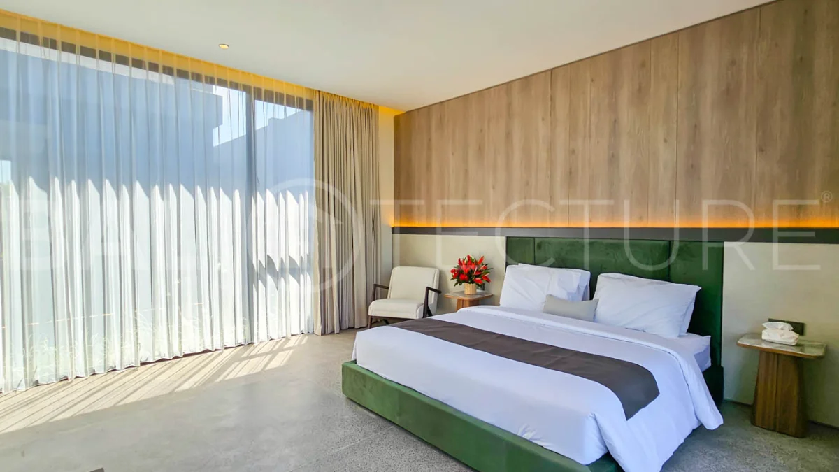 Modern two-storey luxury villa in Ubud featuring a private swimming pool, lush tropical landscaping, floor-to-ceiling glass doors, and a stylish contemporary exterior.