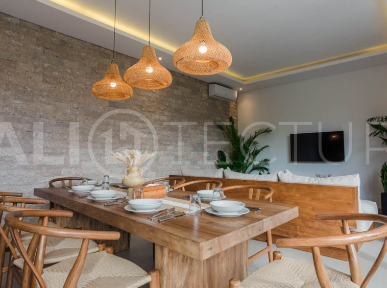 Four-bedroom furnished villa in Padonan, Canggu, featuring three bathrooms, a guest powder room, a private swimming pool, a spacious terrace, a balcony, and flexible indoor-outdoor living spaces, available on a 26-year leasehold.
