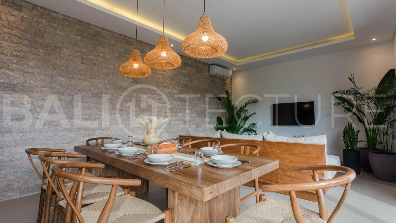 Four-bedroom furnished villa in Padonan, Canggu, featuring three bathrooms, a guest powder room, a private swimming pool, a spacious terrace, a balcony, and flexible indoor-outdoor living spaces, available on a 26-year leasehold.