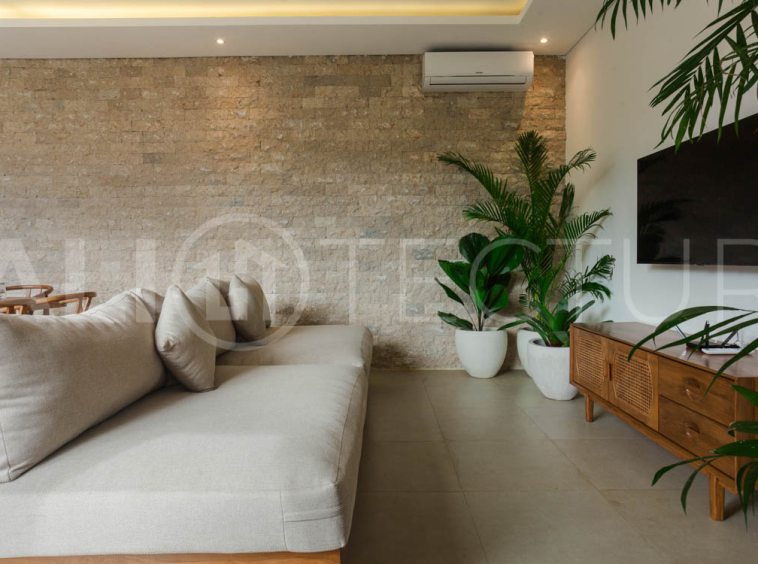 Four-bedroom furnished villa in Padonan, Canggu, featuring three bathrooms, a guest powder room, a private swimming pool, a spacious terrace, a balcony, and flexible indoor-outdoor living spaces, available on a 26-year leasehold.