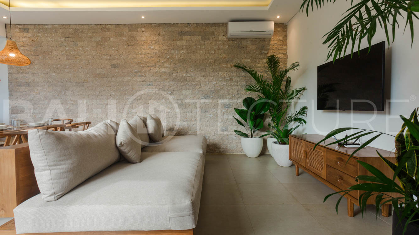 Four-bedroom furnished villa in Padonan, Canggu, featuring three bathrooms, a guest powder room, a private swimming pool, a spacious terrace, a balcony, and flexible indoor-outdoor living spaces, available on a 26-year leasehold.