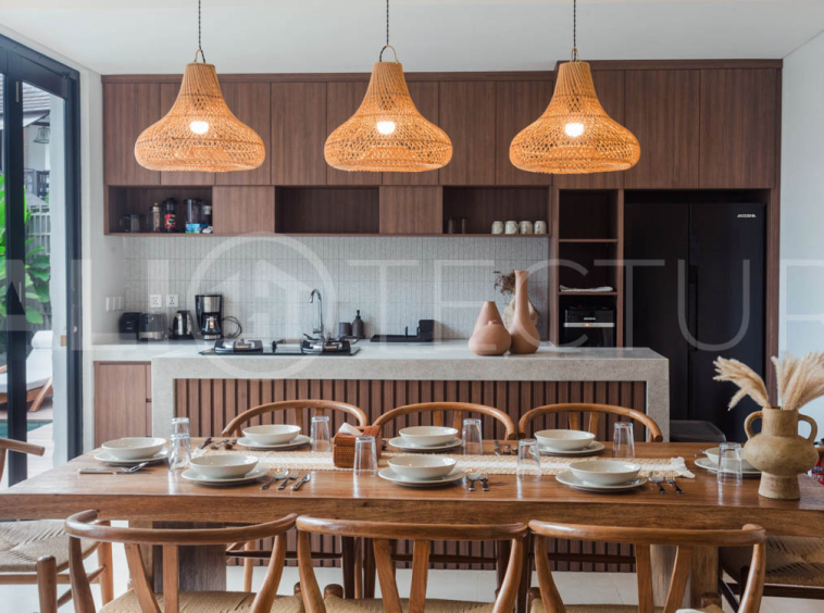 Four-bedroom furnished villa in Padonan, Canggu, featuring three bathrooms, a guest powder room, a private swimming pool, a spacious terrace, a balcony, and flexible indoor-outdoor living spaces, available on a 26-year leasehold.