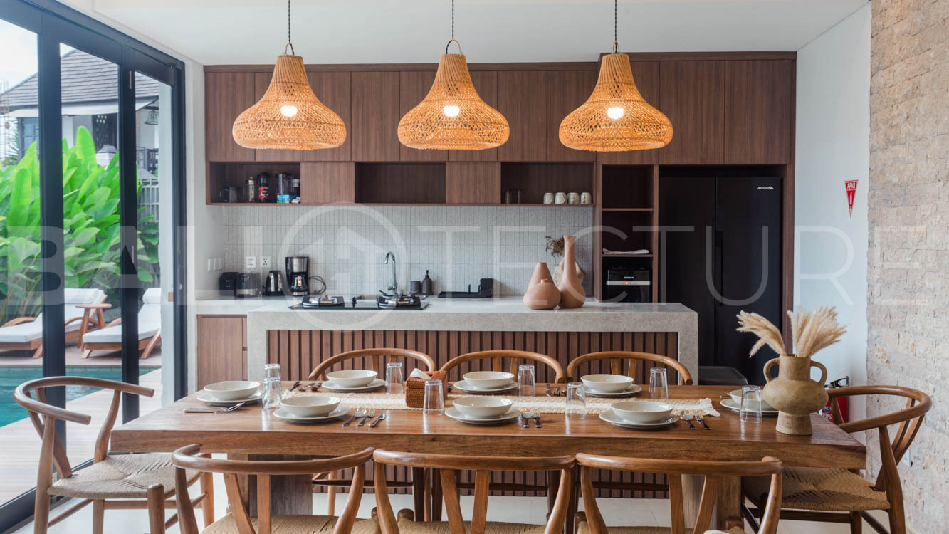 Four-bedroom furnished villa in Padonan, Canggu, featuring three bathrooms, a guest powder room, a private swimming pool, a spacious terrace, a balcony, and flexible indoor-outdoor living spaces, available on a 26-year leasehold.